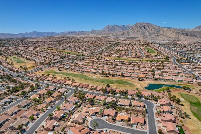 birds eye view of property with view of golf course, a residential view, and a water and mountain view