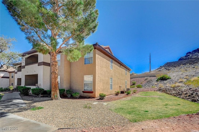 view of home's exterior featuring a yard and stucco siding