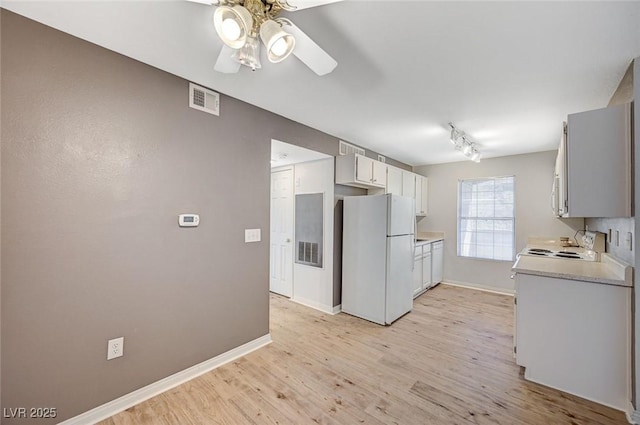 231 W Horizon Ridge Parkway Unit 426, Henderson, NV 89012 - kitchen featuring baseboards, visible vents, light wood-style flooring, freestanding refrigerator, and light countertops