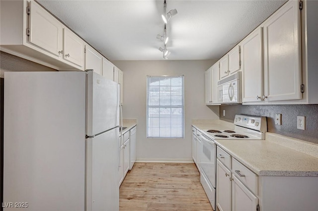 231 W Horizon Ridge Parkway Unit 426, Henderson, NV 89012 - kitchen featuring light wood finished floors, white appliances, white cabinets, and light countertops