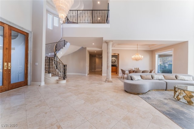 2221 Glenbrook Way, Las Vegas, NV 89117 - living room featuring stairway, a towering ceiling, a wealth of natural light, and a chandelier