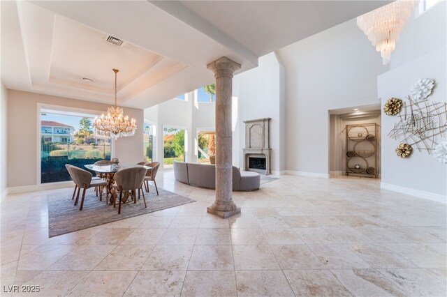 2221 Glenbrook Way, Las Vegas, NV 89117 - dining space with visible vents, baseboards, a fireplace, a notable chandelier, and a raised ceiling