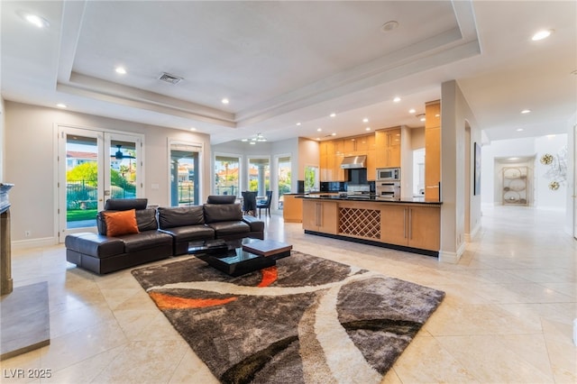 2221 Glenbrook Way, Las Vegas, NV 89117 - living room with a tray ceiling, visible vents, and a healthy amount of sunlight