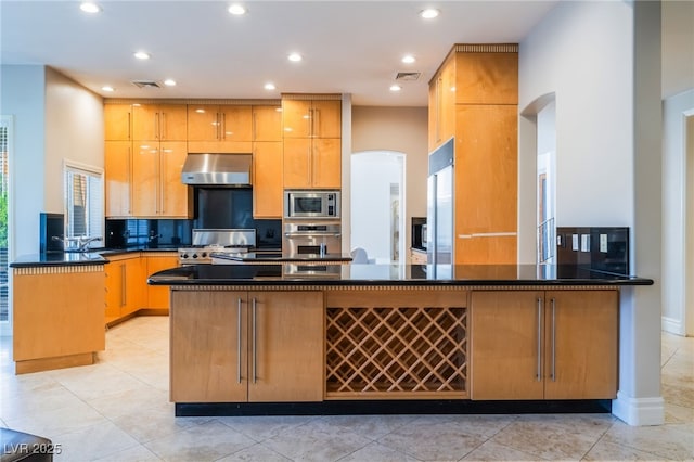 2221 Glenbrook Way, Las Vegas, NV 89117 - kitchen featuring visible vents, extractor fan, built in appliances, a peninsula, and arched walkways
