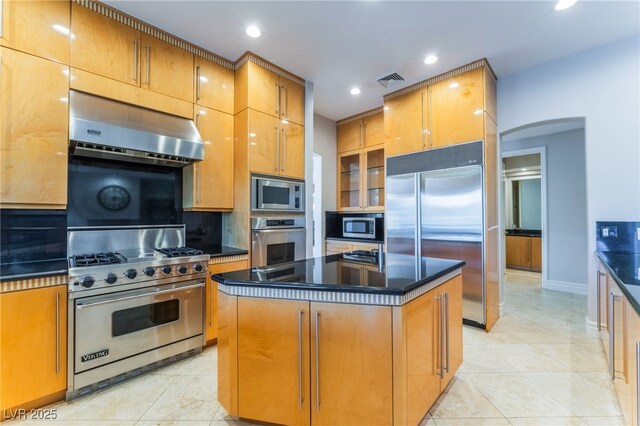2221 Glenbrook Way, Las Vegas, NV 89117 - kitchen featuring visible vents, arched walkways, under cabinet range hood, built in appliances, and dark countertops