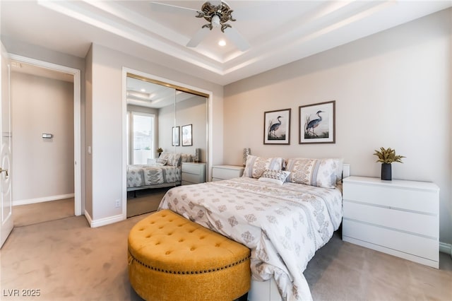 2221 Glenbrook Way, Las Vegas, NV 89117 - bedroom with light carpet, a raised ceiling, recessed lighting, a closet, and baseboards