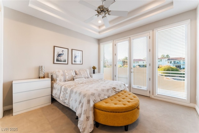 2221 Glenbrook Way, Las Vegas, NV 89117 - bedroom with light colored carpet, a raised ceiling, a ceiling fan, and access to outside