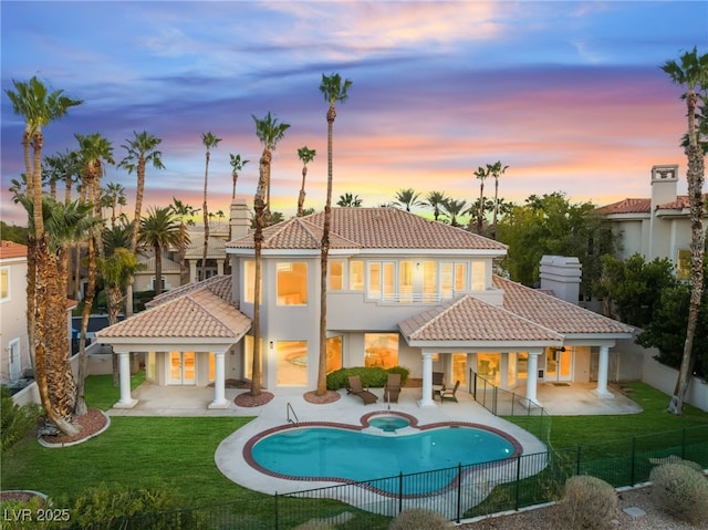 2221 Glenbrook Way, Las Vegas, NV 89117 - back of property featuring a yard, a patio, a fenced backyard, and a tile roof