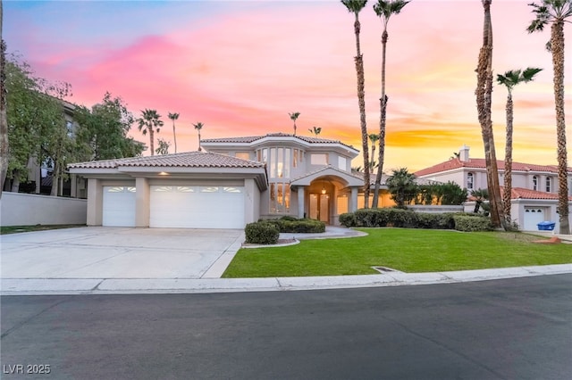 2221 Glenbrook Way, Las Vegas, NV 89117 - mediterranean / spanish home featuring a front lawn, a tiled roof, stucco siding, a garage, and driveway