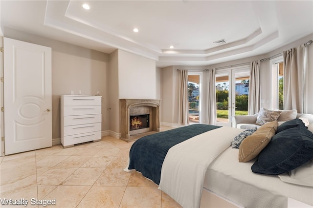 2221 Glenbrook Way, Las Vegas, NV 89117 - bedroom featuring visible vents, a tray ceiling, recessed lighting, a premium fireplace, and baseboards