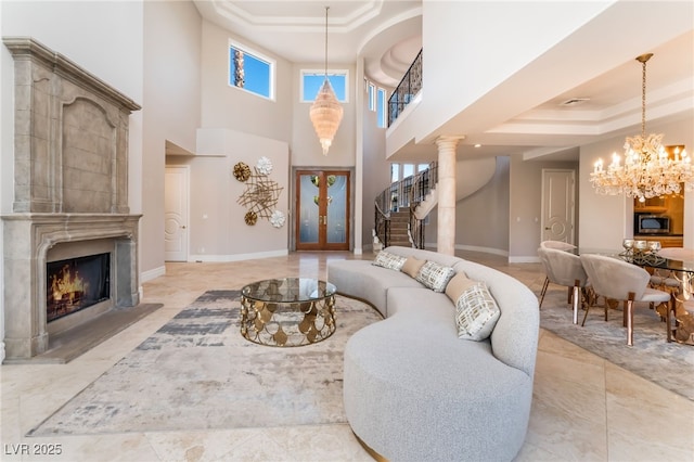 2221 Glenbrook Way, Las Vegas, NV 89117 - living room featuring visible vents, baseboards, a tray ceiling, a fireplace, and a chandelier