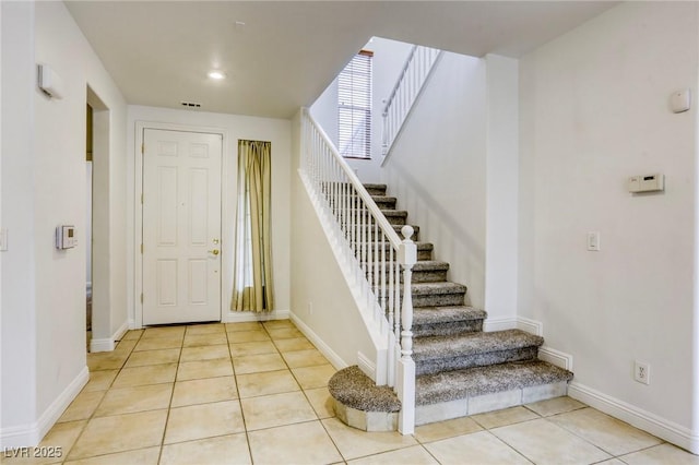 foyer featuring visible vents, baseboards, stairs, light tile patterned floors, and recessed lighting