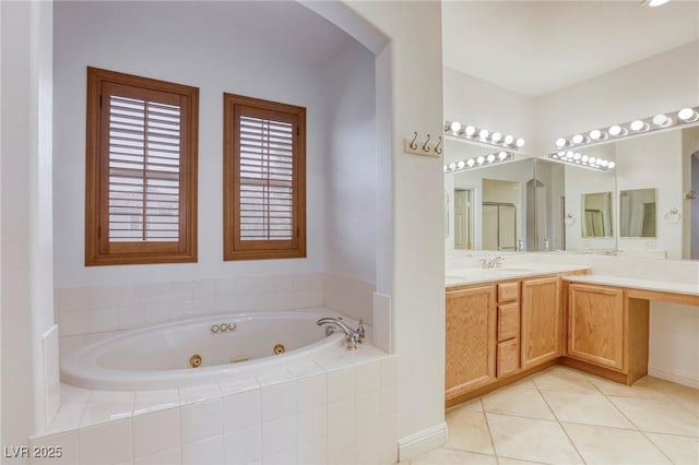 full bathroom with tile patterned floors, a tub with jets, and vanity