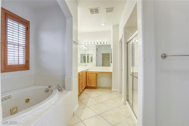 bathroom featuring visible vents, a whirlpool tub, a stall shower, and vanity