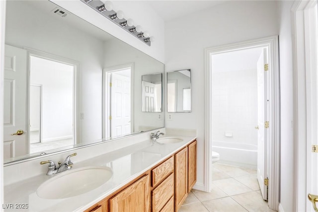 bathroom with tile patterned floors, visible vents, toilet, and a sink