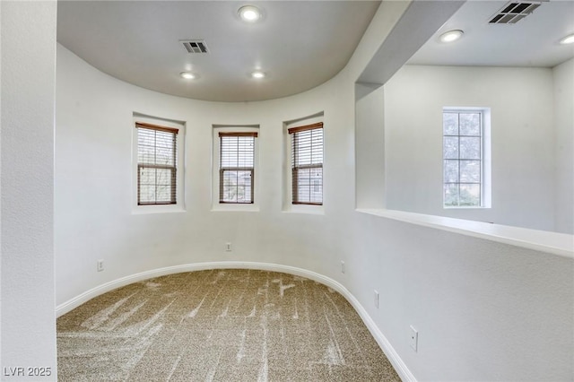 carpeted spare room featuring visible vents, recessed lighting, and baseboards