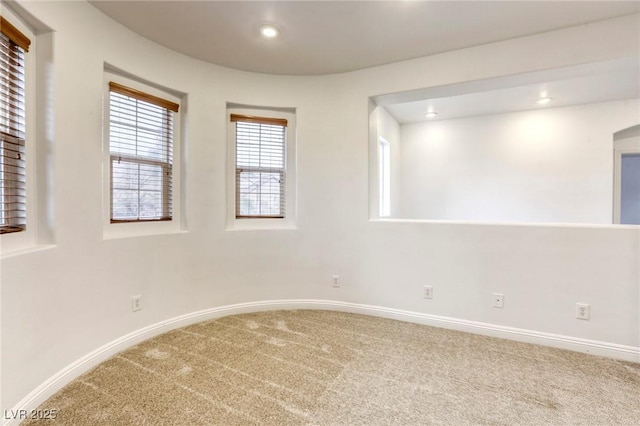 empty room with carpet flooring, recessed lighting, and baseboards