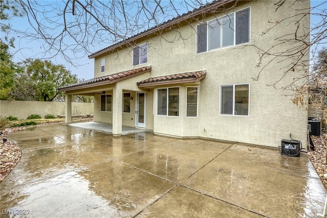 back of house with a patio, cooling unit, fence, stucco siding, and a tile roof