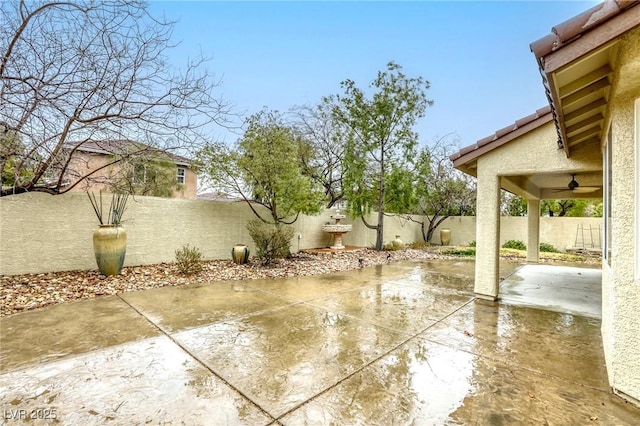 view of patio with a fenced backyard and a ceiling fan