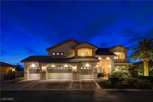 mediterranean / spanish-style house featuring concrete driveway and stucco siding