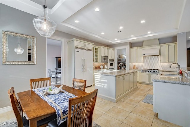 dining room featuring light tile patterned floors, a raised ceiling, and recessed lighting