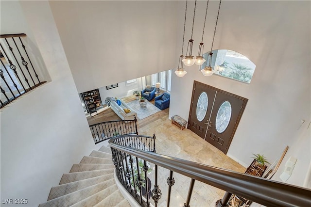 entrance foyer featuring stairway and a high ceiling