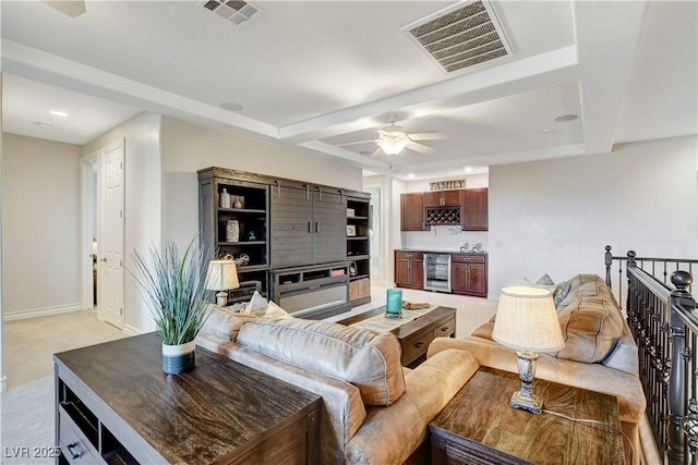 living room featuring baseboards, beverage cooler, visible vents, and light carpet