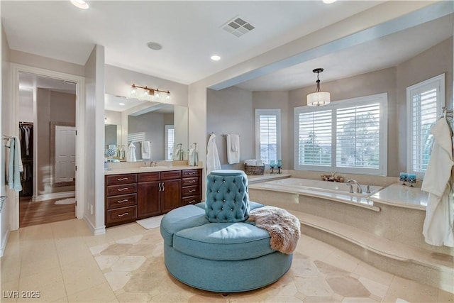 bathroom featuring visible vents, recessed lighting, tile patterned flooring, a bath, and vanity