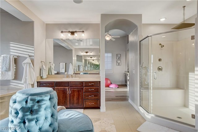 bathroom featuring vanity, a ceiling fan, baseboards, a stall shower, and tile patterned floors