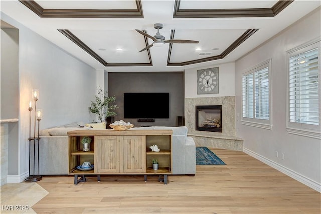 living room featuring light wood-type flooring, ceiling fan, and crown molding