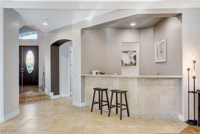 entrance foyer featuring tile patterned flooring, recessed lighting, and baseboards