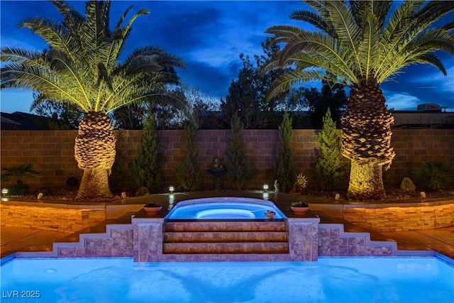 view of swimming pool with a fenced backyard and a hot tub