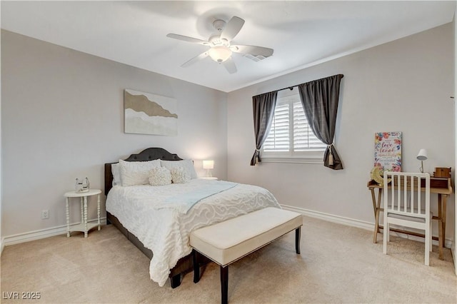 bedroom featuring a ceiling fan, light colored carpet, and baseboards