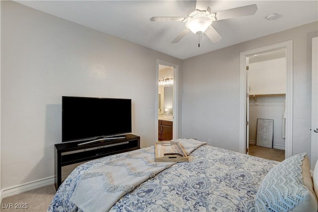 bedroom featuring ensuite bath, a closet, carpet flooring, baseboards, and ceiling fan