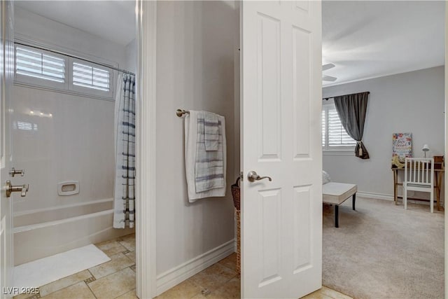 bathroom featuring shower / bath combo with shower curtain and baseboards