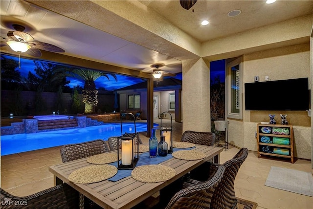 view of patio with outdoor dining space, a ceiling fan, a fenced in pool, and a hot tub