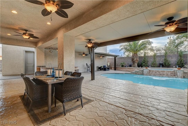 view of patio with outdoor dining area, fence, a fenced in pool, and ceiling fan