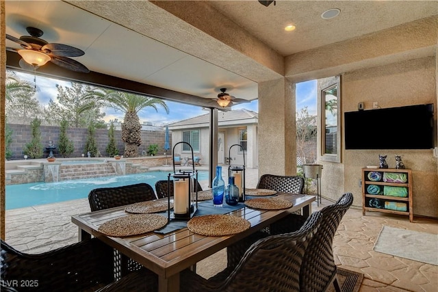 exterior space with a fenced in pool, outdoor dining space, a ceiling fan, and fence