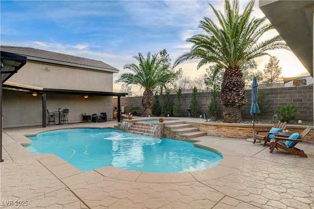 view of pool featuring a fenced in pool, an in ground hot tub, a fenced backyard, and a patio