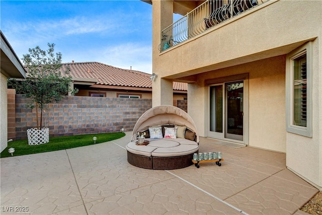 view of patio / terrace with a balcony and fence