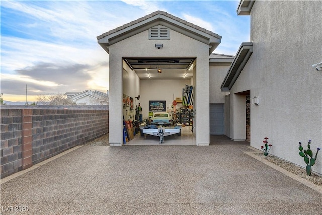 exterior space with stucco siding and fence