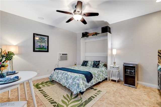 bedroom with a ceiling fan, baseboards, and a wall mounted AC