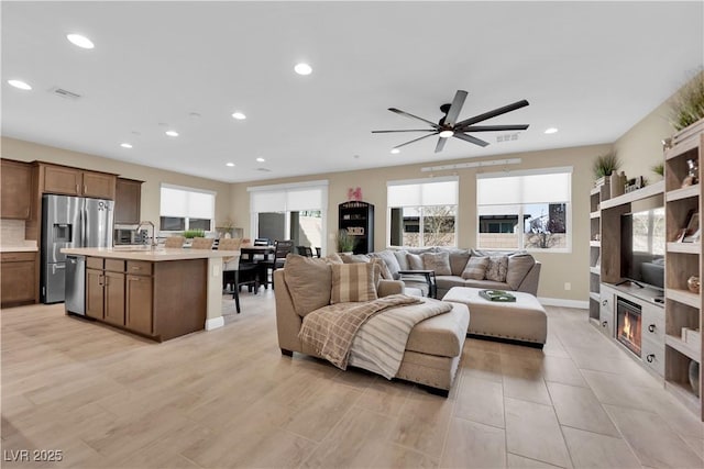 living area with light wood-style flooring, plenty of natural light, recessed lighting, and visible vents