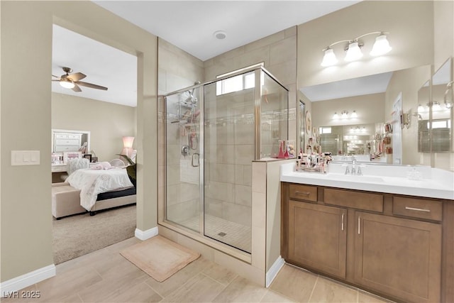 ensuite bathroom featuring a ceiling fan, vanity, a stall shower, and ensuite bathroom