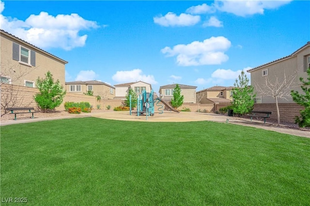 view of yard with a residential view, a playground, and fence