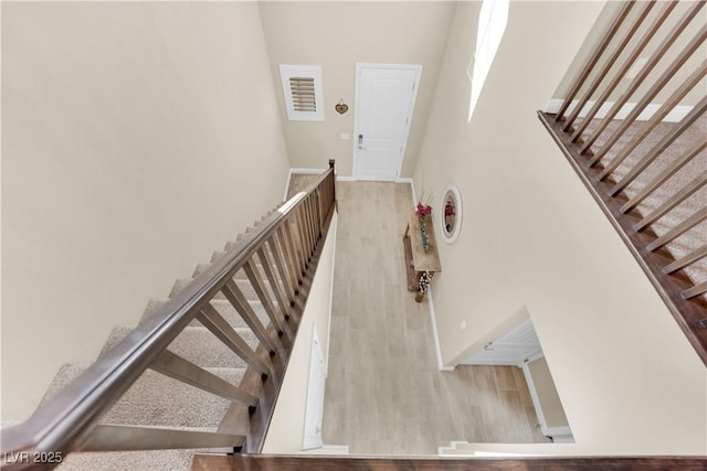 stairs featuring wood finished floors