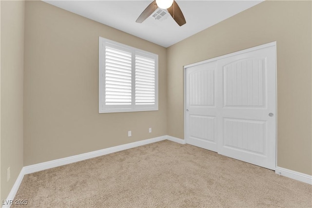 unfurnished bedroom featuring a closet, baseboards, and carpet