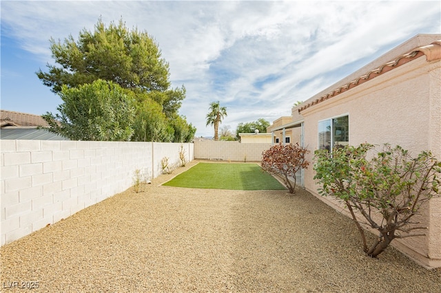 view of yard featuring a patio area and a fenced backyard