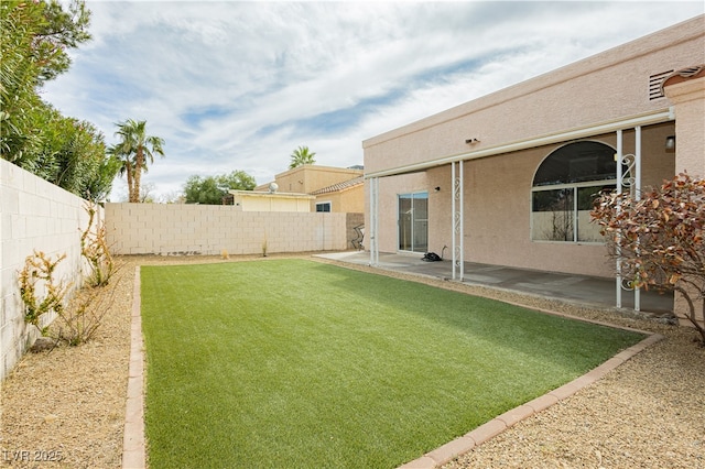 view of yard with a patio area and a fenced backyard