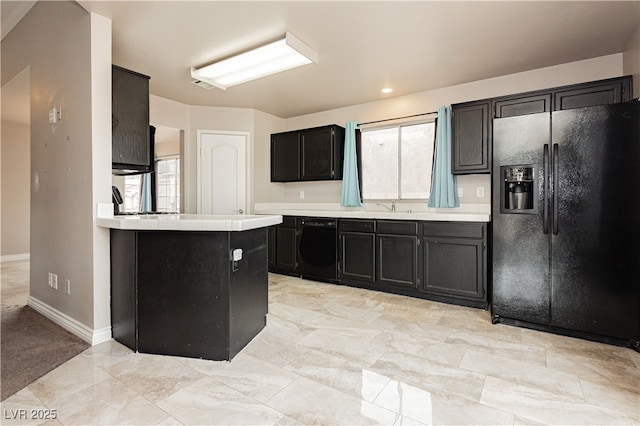 kitchen with black appliances, a sink, tile countertops, baseboards, and dark cabinets